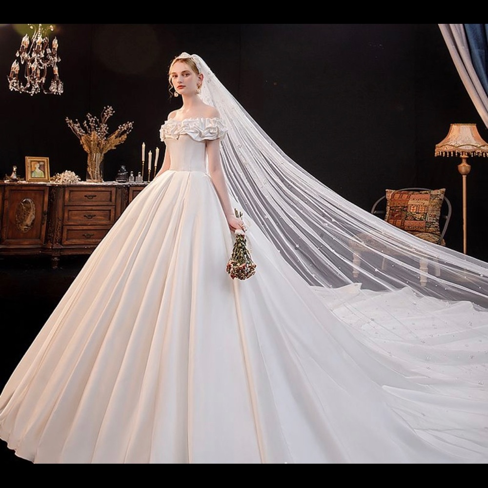 New off-shoulder wedding dress, still in package